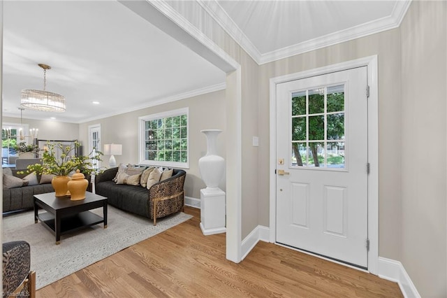 506 Audubon Dr, Greensboro, NC 27410 - living room featuring light wood-type flooring, crown molding, and a chandelier