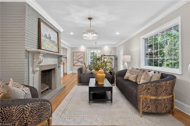 506 Audubon Dr, Greensboro, NC 27410 - living room featuring plenty of natural light, light wood-style floors, a chandelier, recessed lighting, and ornamental molding
