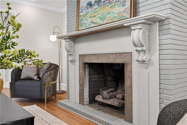 506 Audubon Dr, Greensboro, NC 27410 - detailed view of a tiled fireplace, ornamental molding, and wood finished floors