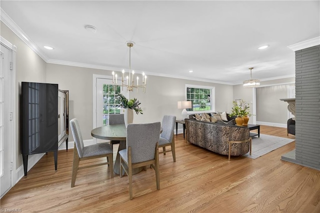506 Audubon Dr, Greensboro, NC 27410 - dining room with a chandelier, light wood finished floors, recessed lighting, ornamental molding, and a brick fireplace