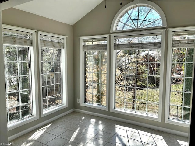 unfurnished sunroom with lofted ceiling and a healthy amount of sunlight