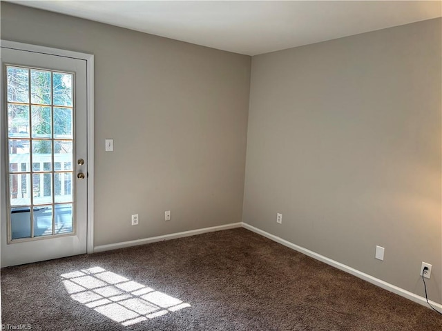 spare room with carpet and baseboards