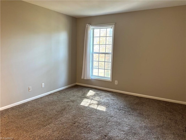 empty room with carpet flooring and baseboards