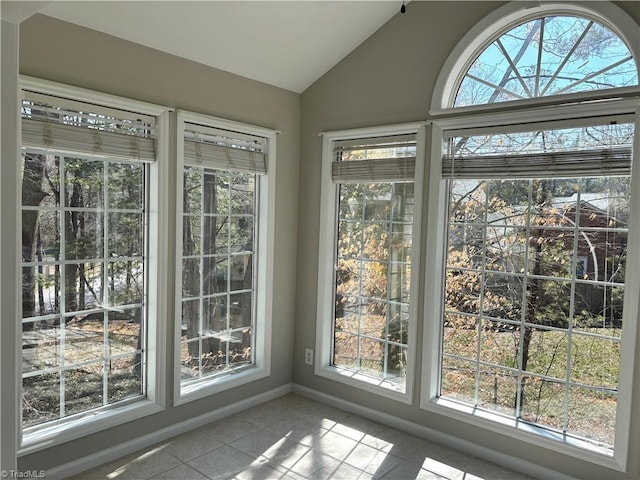 unfurnished sunroom featuring lofted ceiling and a healthy amount of sunlight