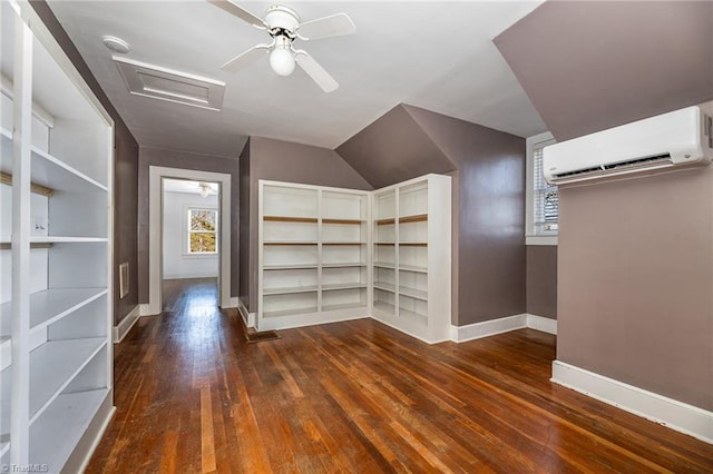 interior space with ceiling fan, an AC wall unit, and dark hardwood / wood-style flooring