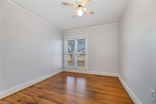 spare room featuring hardwood / wood-style flooring, ceiling fan, and crown molding