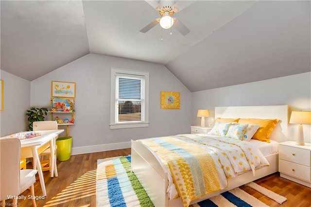 bedroom with hardwood / wood-style flooring, vaulted ceiling, and ceiling fan