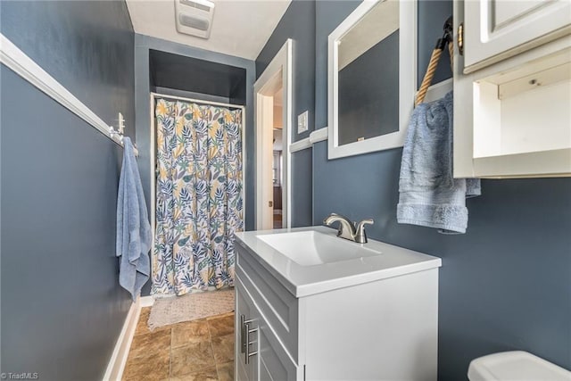 bathroom featuring vanity and toilet