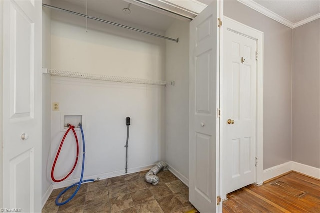 washroom with hookup for a washing machine and ornamental molding