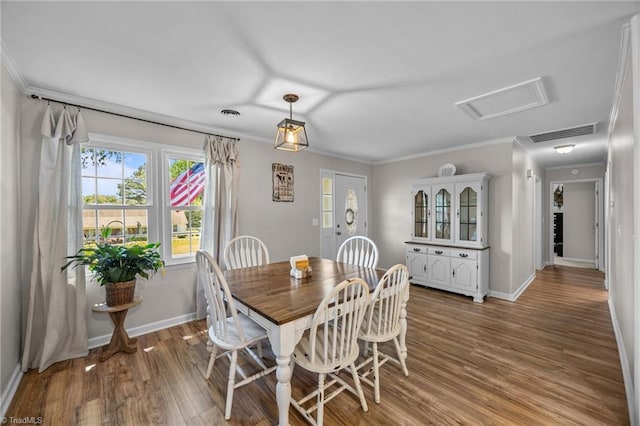 202 Stokes Forest Dr, King, NC 27021 - dining space with crown molding, attic access, light wood-style floors, and baseboards