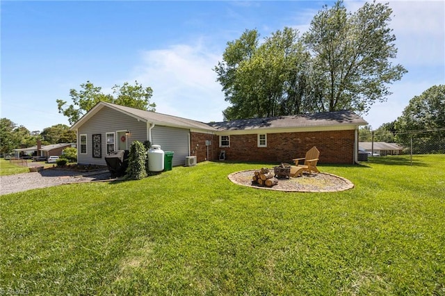202 Stokes Forest Dr, King, NC 27021 - rear view of house featuring a fire pit, cooling unit, and brick siding