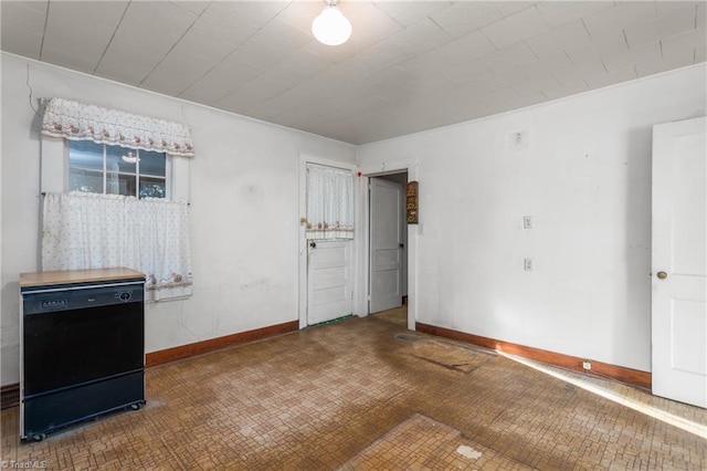 unfurnished bedroom featuring dark tile floors and fridge