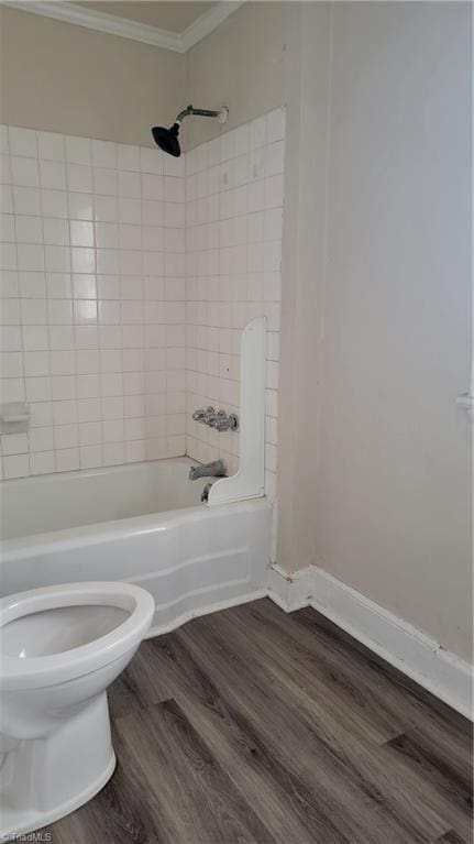 bathroom featuring ornamental molding, toilet, shower / bath combination, and wood finished floors