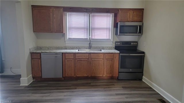 kitchen with light countertops, appliances with stainless steel finishes, a sink, and visible vents