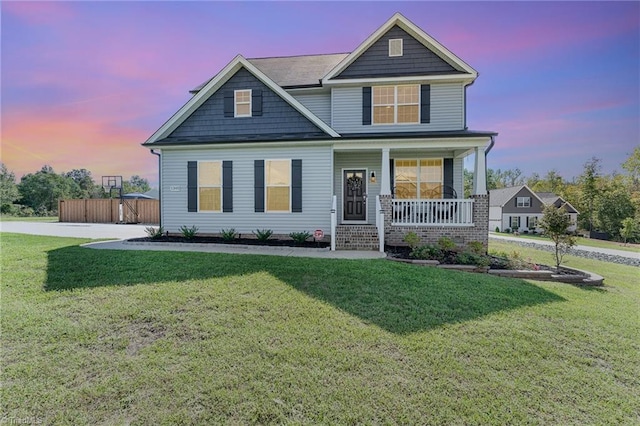 craftsman-style house featuring a yard and a porch