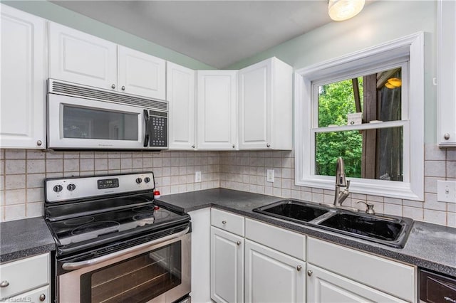1093 Gordon Rd, Pinnacle, NC 27043 - kitchen with electric stove, dark countertops, white cabinets, and decorative backsplash