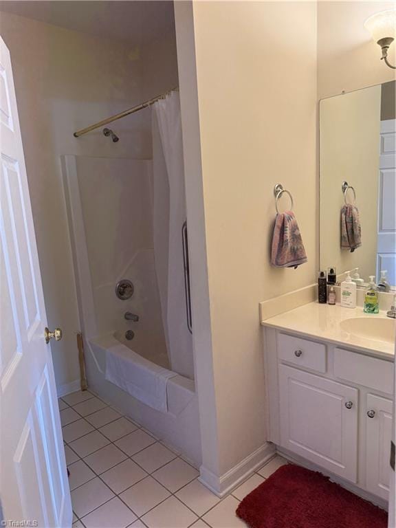 full bathroom with tile patterned floors, baseboards, shower / tub combo, and vanity