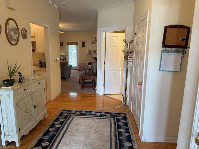 corridor with baseboards and light wood-style flooring