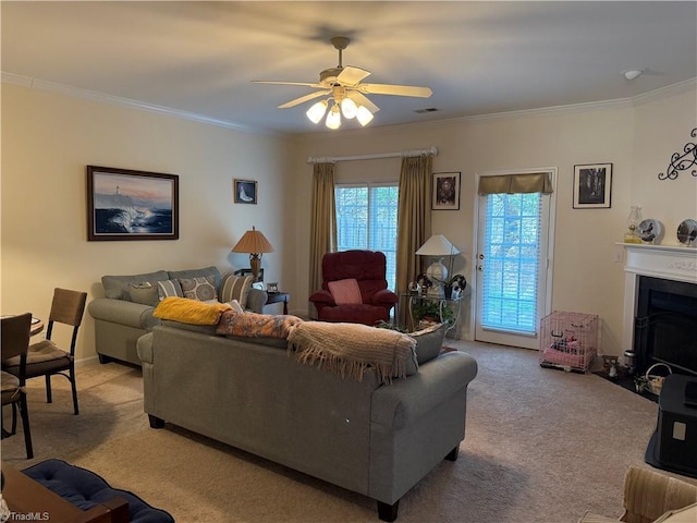 living area with visible vents, carpet floors, a fireplace with flush hearth, ceiling fan, and crown molding