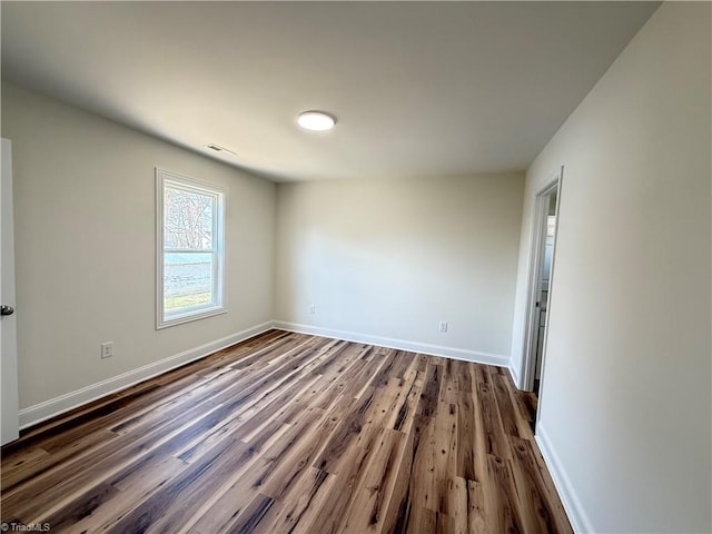 503 W End Blvd, Madison, NC 27025 - empty room featuring baseboards and dark wood-type flooring