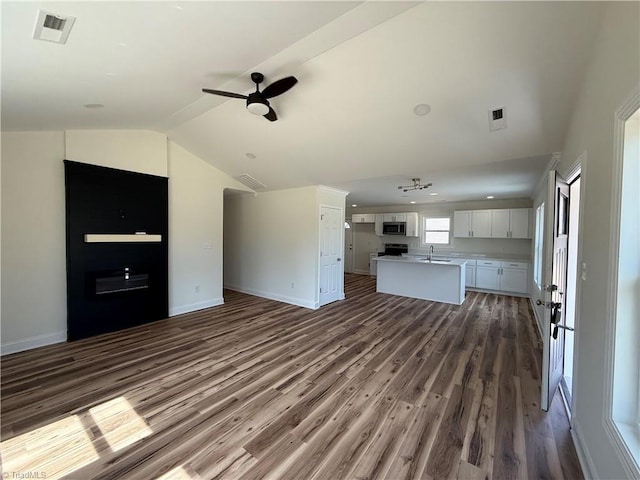 503 W End Blvd, Madison, NC 27025 - unfurnished living room with dark wood finished floors, ceiling fan, lofted ceiling, baseboards, and a fireplace