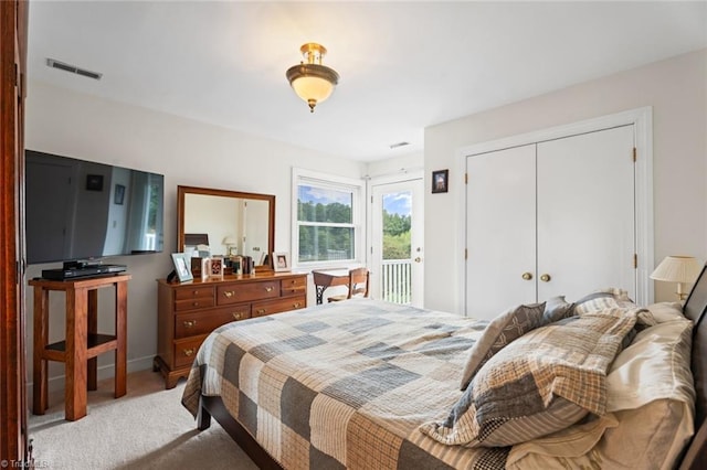 bedroom with a closet, carpet, and visible vents