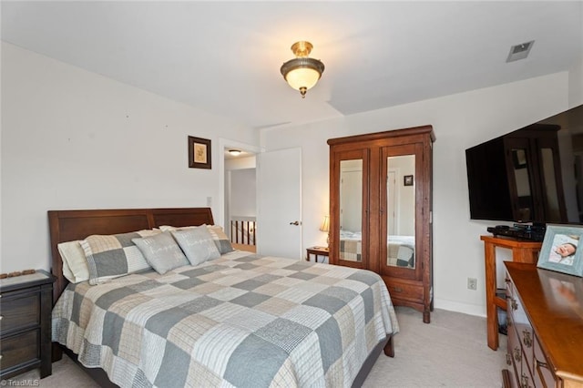 bedroom featuring light colored carpet and baseboards