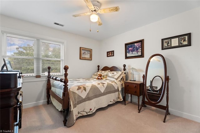 bedroom featuring a ceiling fan, light colored carpet, visible vents, and baseboards