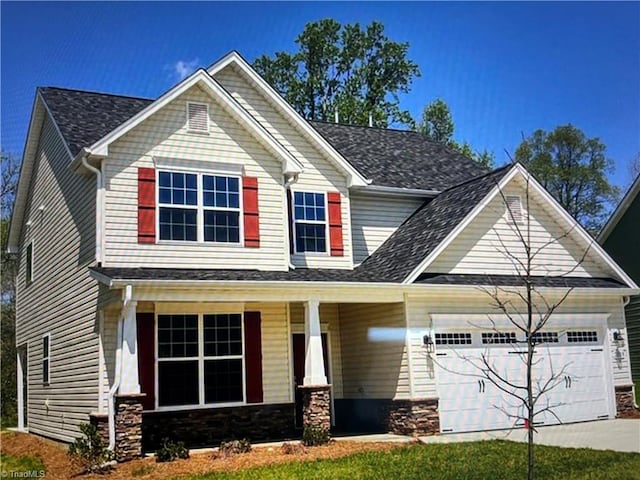 craftsman-style home with a garage, covered porch, and a front lawn