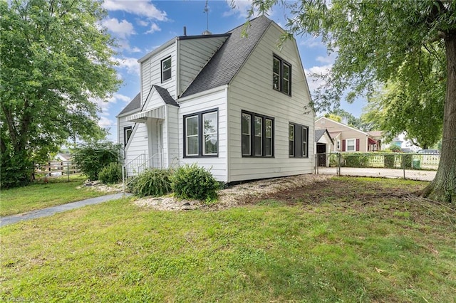 view of side of property with a lawn