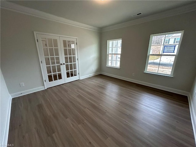 unfurnished room featuring dark hardwood / wood-style flooring, crown molding, and french doors