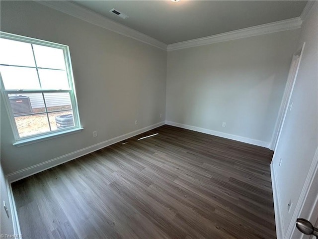 spare room featuring crown molding and dark hardwood / wood-style floors