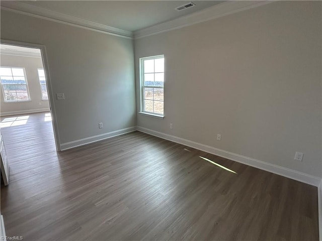 spare room with crown molding and dark hardwood / wood-style flooring