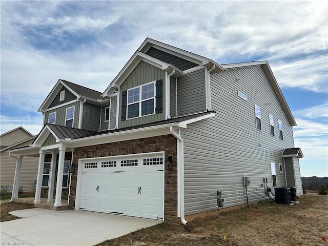 view of home's exterior with a garage and central air condition unit