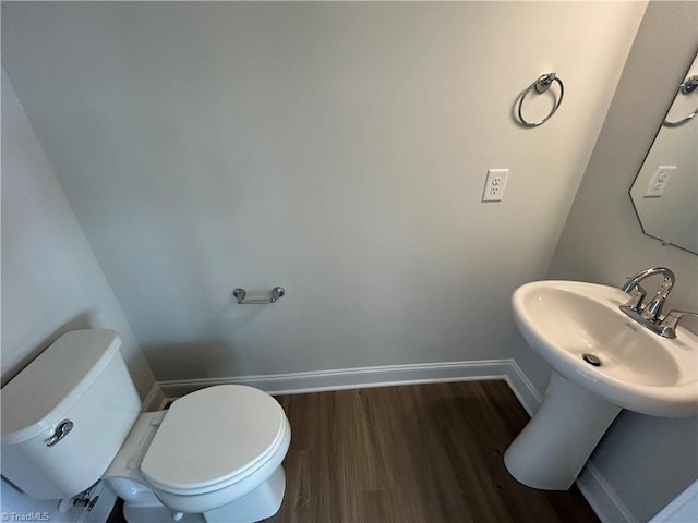 bathroom featuring hardwood / wood-style flooring and toilet