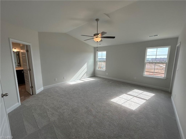 carpeted empty room with ceiling fan and lofted ceiling