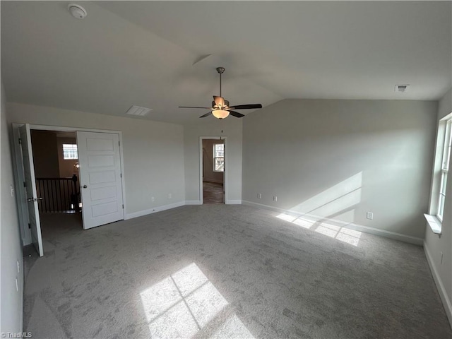 unfurnished living room featuring ceiling fan, carpet flooring, and vaulted ceiling