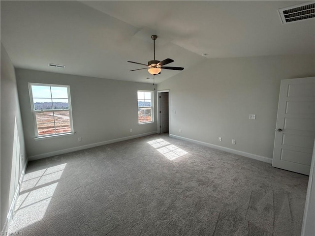 empty room with ceiling fan, light colored carpet, and lofted ceiling