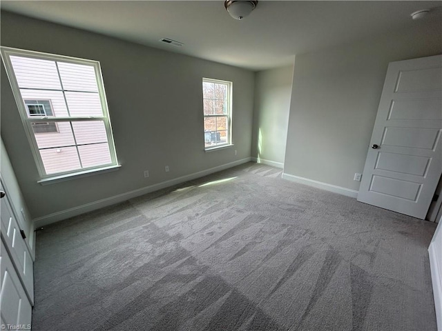 spare room featuring light colored carpet