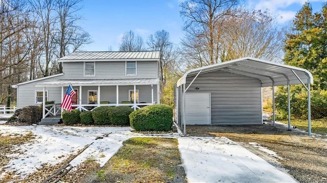 bungalow featuring an outbuilding, a porch, and a carport