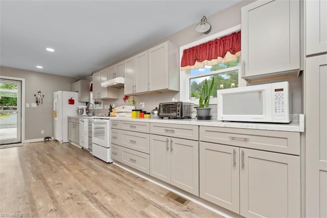 151 N Shore Dr, Lexington, NC 27292 - kitchen with white appliances, light countertops, a toaster, under cabinet range hood, and visible vents