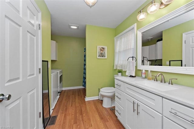 151 N Shore Dr, Lexington, NC 27292 - bathroom with wood finished floors, vanity, baseboards, toilet, and washer and clothes dryer