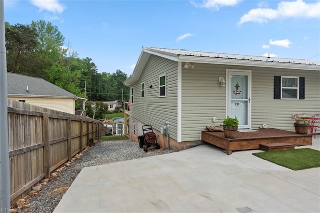 151 N Shore Dr, Lexington, NC 27292 - back of house featuring fence, a deck, a patio area, and metal roof
