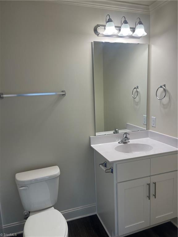 bathroom featuring crown molding, vanity, and toilet