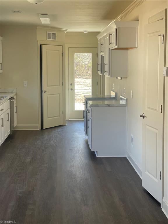 kitchen with white cabinetry and dark hardwood / wood-style flooring