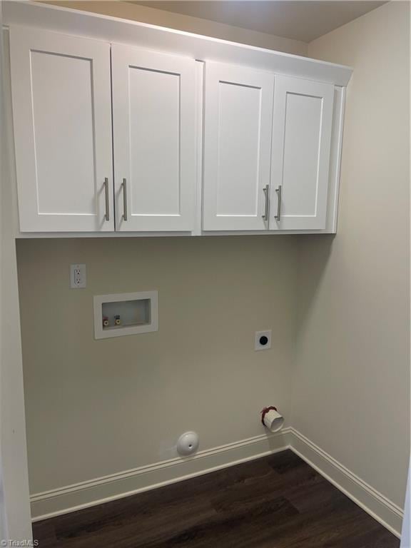 washroom with cabinets, hookup for a washing machine, hookup for an electric dryer, and dark hardwood / wood-style flooring