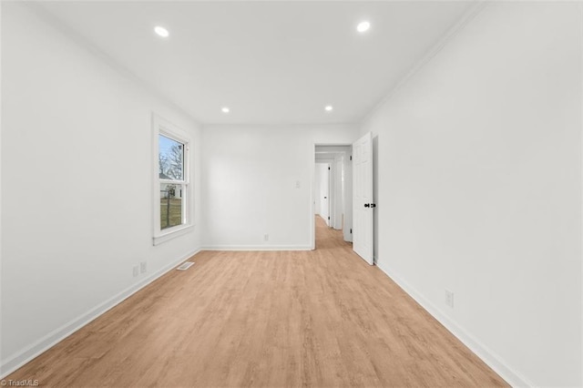 empty room featuring visible vents, recessed lighting, baseboards, and light wood-type flooring