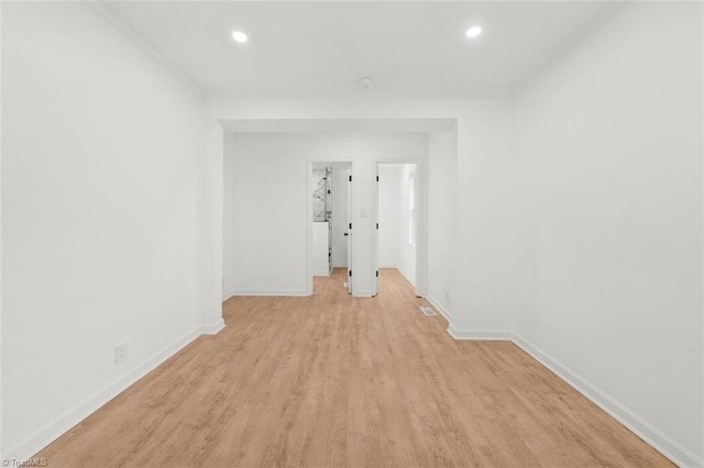 unfurnished room with recessed lighting, baseboards, and light wood finished floors