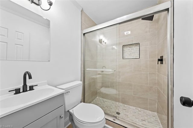 bathroom with vanity, toilet, and a stall shower