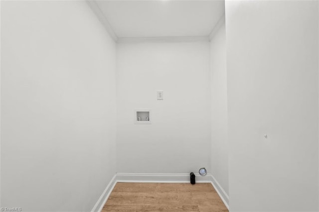 laundry area with baseboards, light wood-type flooring, ornamental molding, washer hookup, and laundry area